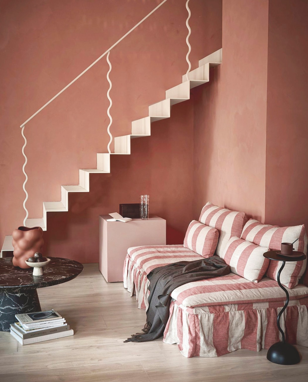 vtwonen muurverf krijtmat, blusher (wand) en soft clay (blok), 1 liter € 27,99. vtwonen laminaat XL Rafter, naturel, per m² € 32,99.M.m.v. polspotten.com (vaas, koffietafel, karaf), hm.com (etagere, opbergbox), zarahome.com (plaid), bemz.com (bankhoes). Overig privébezit. vtwonen 9-2025 | styling Sanne Ketelaar | fotografie Peggy Janssen