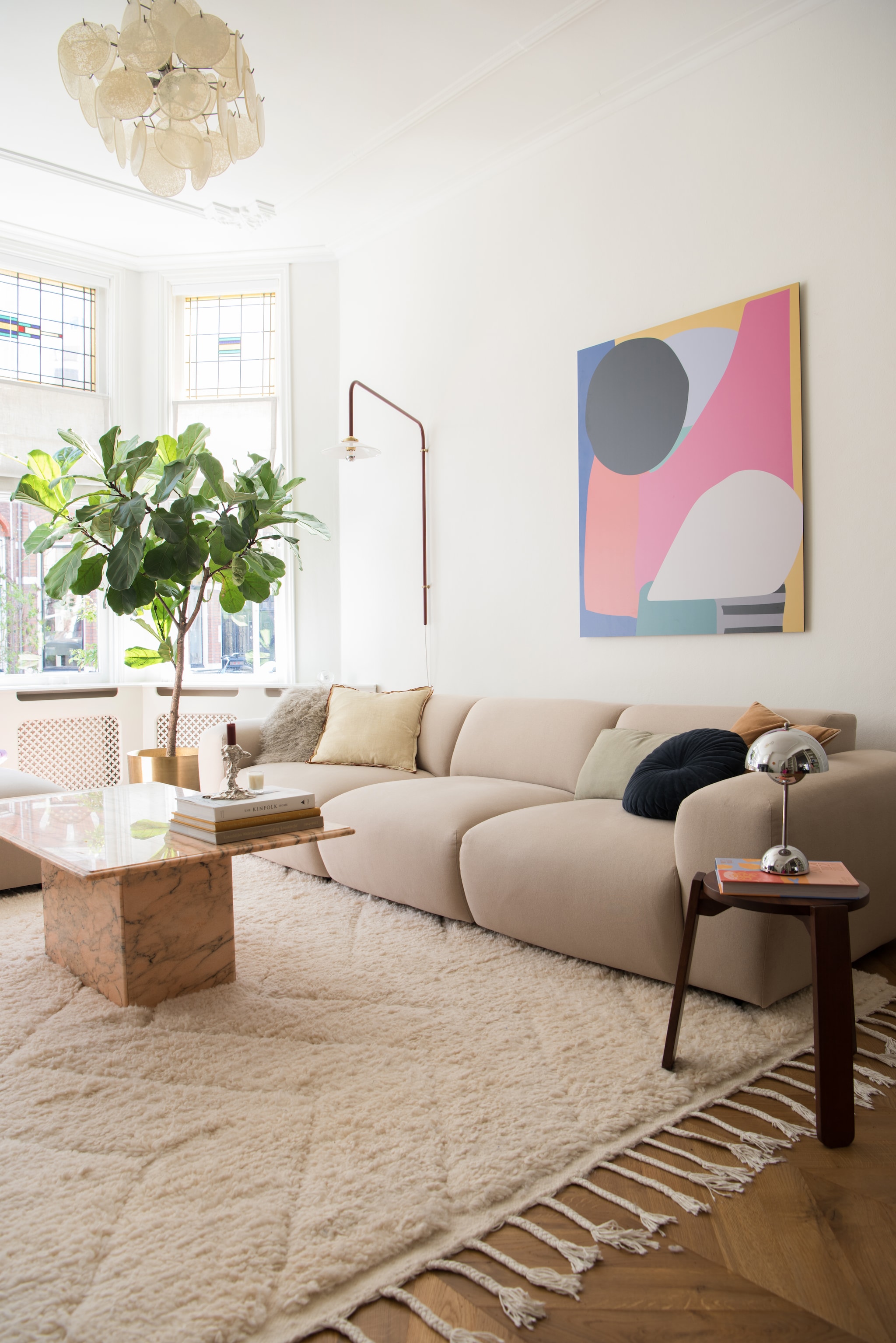 Vloerkleed Marokkaans berberkleed. Bank Cosy sofa van Studio Henk. Hanglamp Marktplaats. Wandlamp Valerie Objects. Schilderij gekregen. Salontafel vintage via Very Vintage Interiors. Bijzettafel H&m Home. Tafellamp Flowerpot van &Tradition. Kussens Zara Home, H&m Home en Loods 5. Plant en bloempot Intratuin. Kandelaar Polspotten.  vtwonen 01-2026 | styling Jasmijn Stegeman | fotografie Anke Leunissen