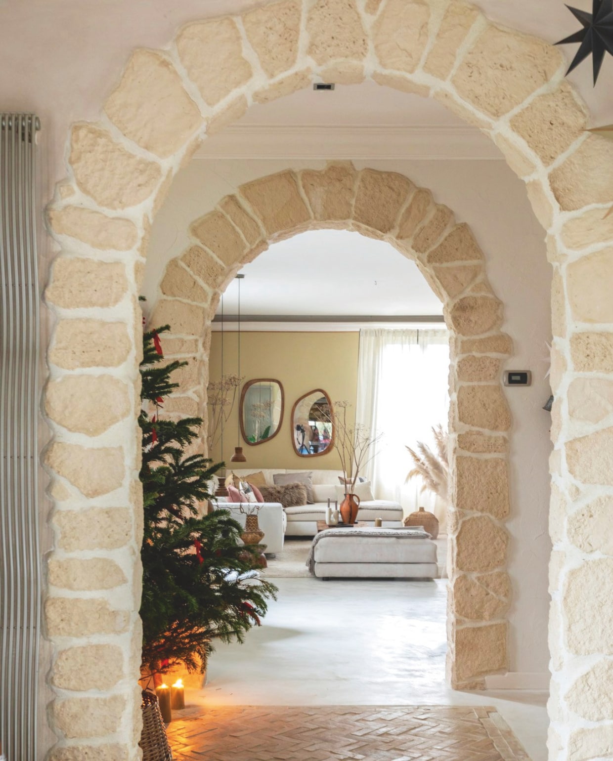 Gepolijste betonnen vloer in Isatis van Maison Étanche. Terracotta vloer Maison Zellige. Bank en hocker Poltronesofà. Vloerkleed Decoweb. Spiegels Made in Meubles. vtwonen Landelijk kerstspecial 2025 | styling Marie-Maud Levron | fotografie Cecile Perrinet Lhermitte | tekstbewerking Britte Kramer