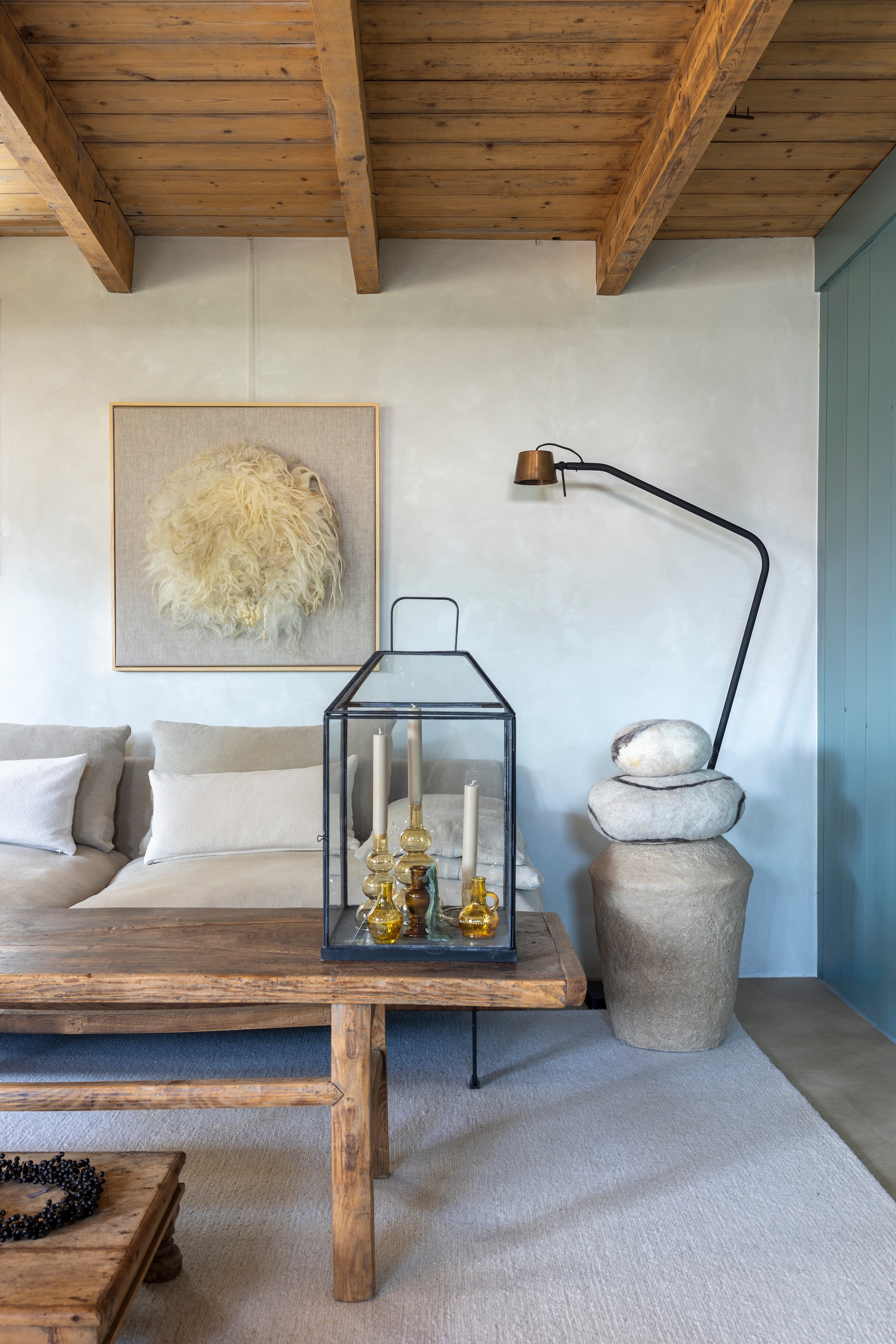 Houten wand kleur Blue Reef van Pure & Original. Stucco wand kleur Krijt en kozijnen kleur Tuinkamer van l’Authentique. Bank Ciel van l’Authentique. Kussens Ml Fabrics. Tafels Aura Peeperkorn. Staande lamp Frezoli Lighting. Lantaarn Chic Antique. Vloerkleed, items in de lantaarn en kandelaars op vensterbank Zv Wonen. Vaas, keien en kunstwerk Zilt & Zacht. Vaas papier-maché J-line. vtwonen Landelijk 02-2026 | fotografie Anneke Gambon