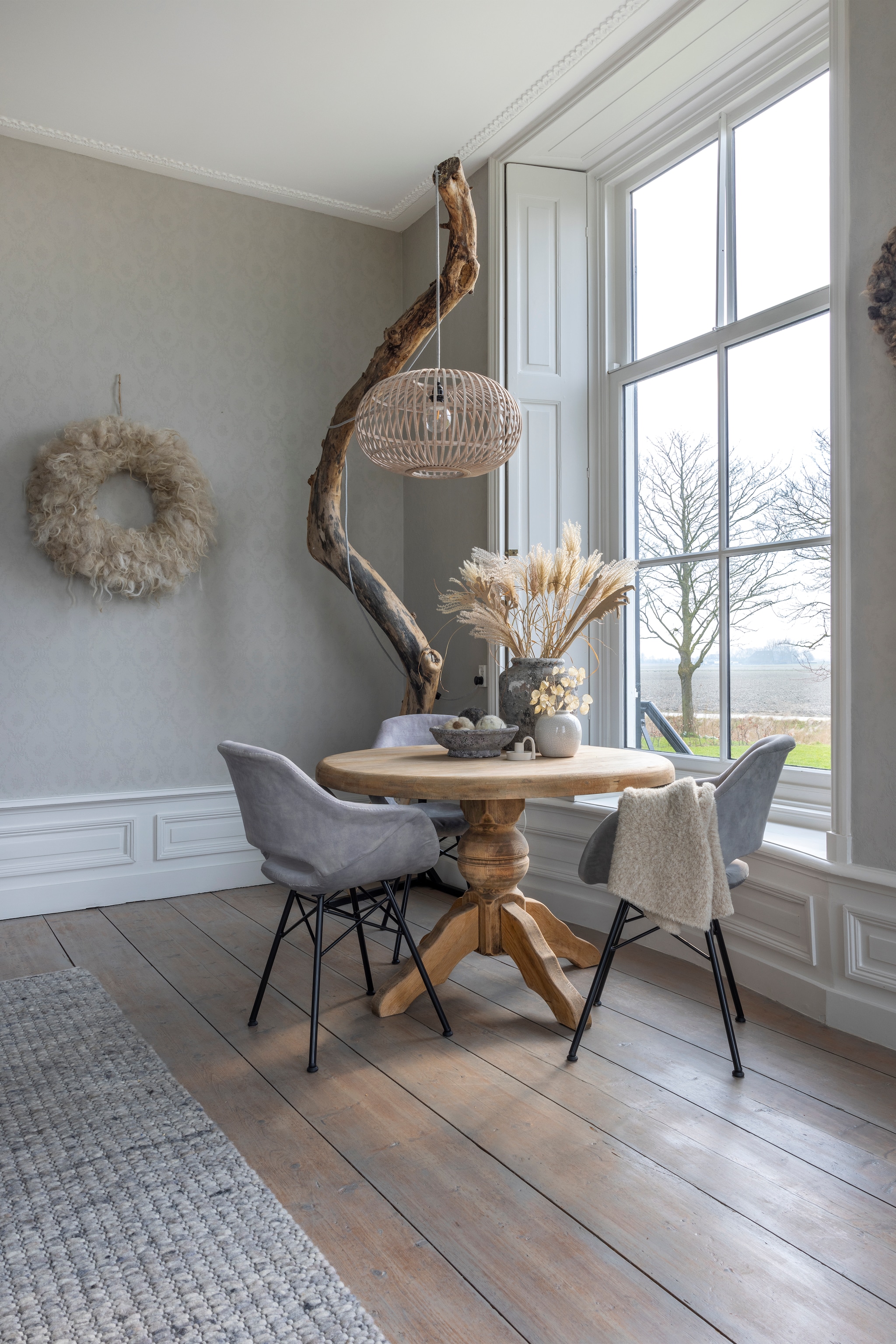 Eettafel erfstuk. Lamp gemaakt door Tsjebbe en Loesanne. Krans WenKR8. Vloerkleed Brinker Carpets. Linnen behang, vloerdelen, raamluiken en lambrisering origineel. vtwonen Landelijk 02-2026 | fotografie Anneke Gambon