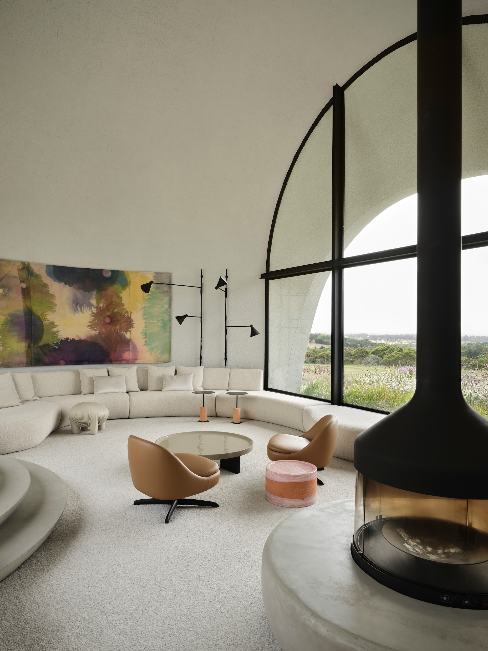 Woonkamer met op maat gemaakte bank. Bijzettafels SP01 Design. Salontafel en leren fauteuils Minotti. Geglazuurde bijzettafel Paola Lenti. Wandverlichting De Padova. Schilderij Lara Merrett. vtwonen Design 01-2026 | productie Living Inside | fotografie Lisa Cohen