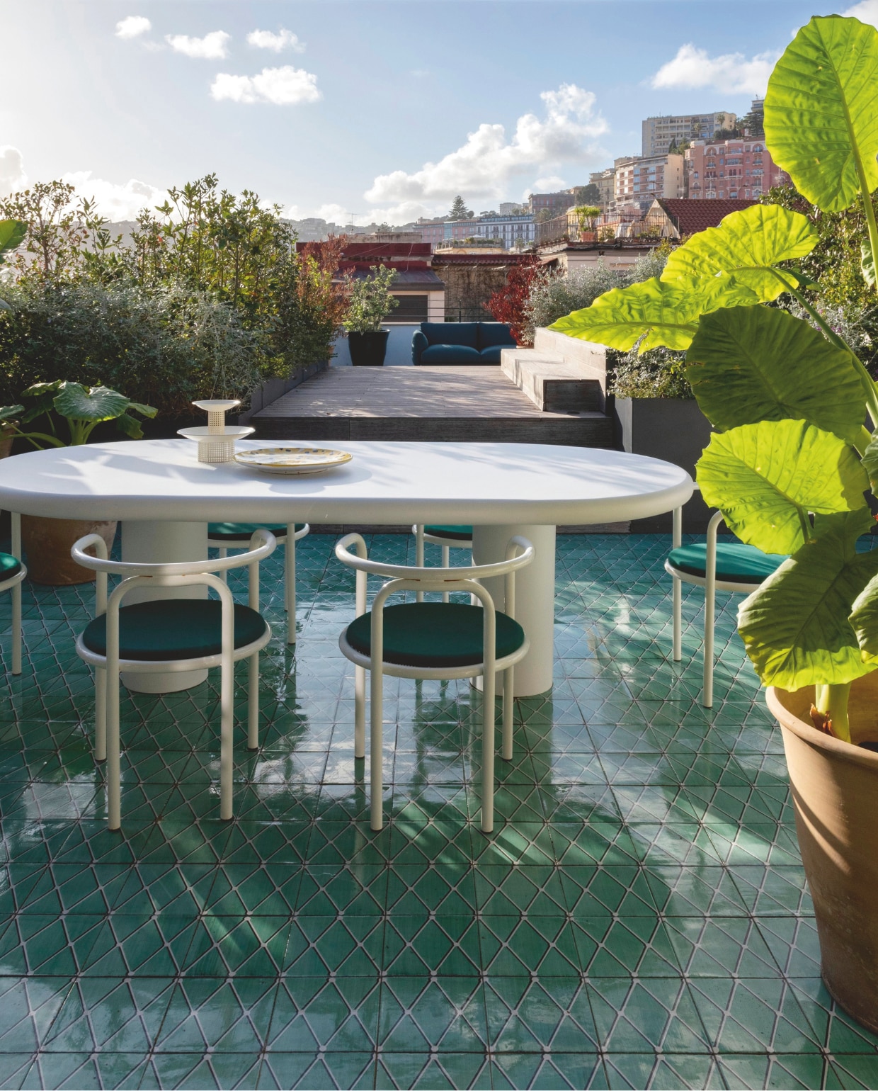 Witgelakte aluminium tafel Studio dell’Uva. Keramieken bord Bazar la Minervetta. Vintage metalen fruitschaal Hoffmann. Stoelen van Gae Aulenti voor Exteta. Vloertegels van Studio dell’Uva voor Galleria Elena. Bank Roma van Kettal. Stijlvol Wonen 10-2025 | fotografie Nathalie Krag | tekstbewerking Tanne Donjacour Gielen