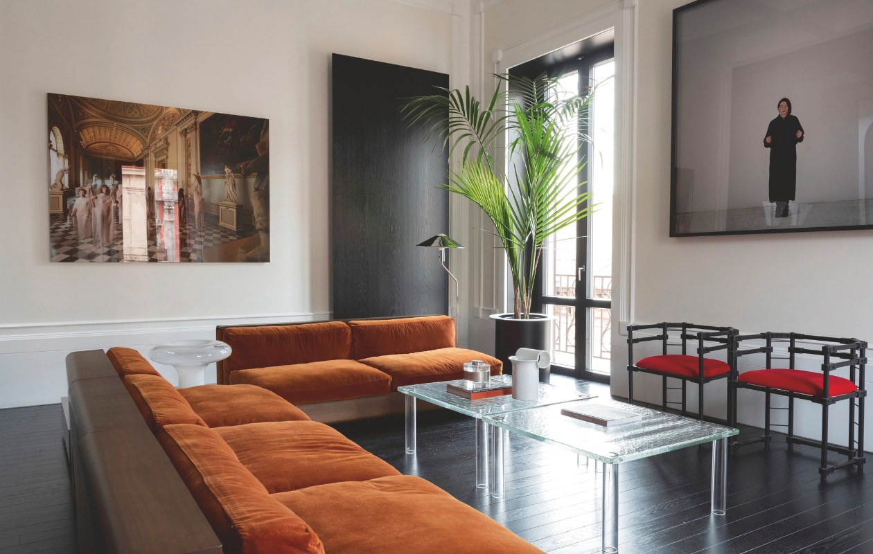 Bank van Roberto Monsani voor Acerbis. Glazen lamp Lesbo van Mangiarotti voor Artemide. Vloerlamp van Hans-Agne Jakobsson. Glazen salontafels van Ronan en Erwan Bouroullec voor Glas Italia met vintage objecten. Vintage stoelen van Massimo Caiafa Design.  Rechts kunstwerk van Marina Abramović. Links kunstwerk vb84.044 van Vanessa Beecroft. Stijlvol Wonen 10-2025 | fotografie Nathalie Krag | tekstbewerking Tanne Donjacour Gielen