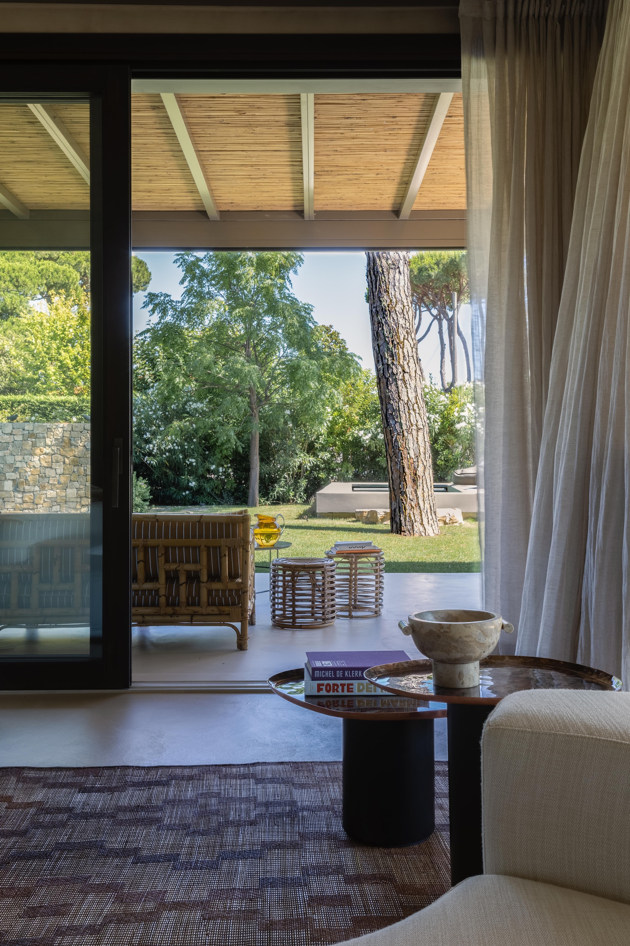 Salontafels Drops van De Castelli. Marokkaans vloerkleed van Soufiane Zarib. Bamboe bank Vivai del Sud. Rieten kruk vintage. vtwonen Design 02-2026 | fotografie Monica Spezia | productie Living Inside