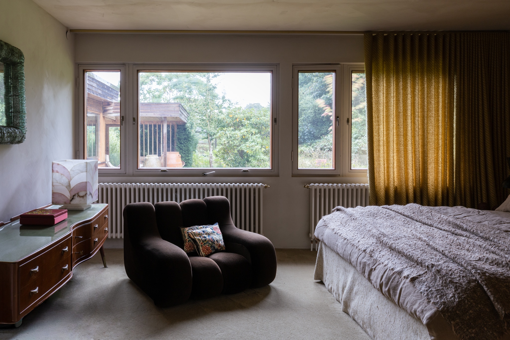 Bed Jensen Beds. Sprei vintage. Italiaans bureau uit de jaren 50. Soortgelijke albasten lamp Artemest. Gordijnen Astrid. Stoel Rosenthal Studio Line. Kussens van Chinese zijde. vtwonen Design 03-2026 | fotografie Monica Spezia | productie Living Inside