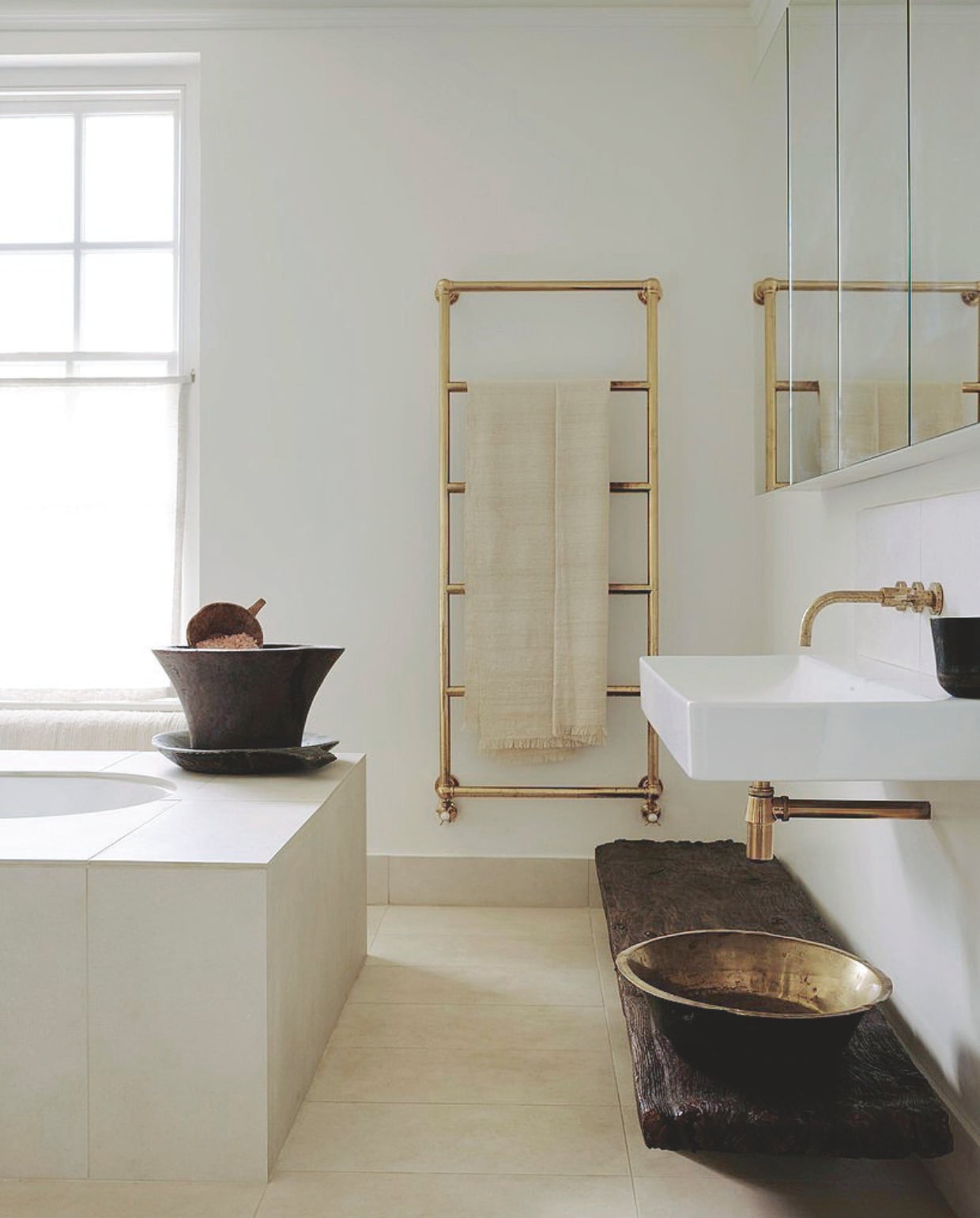 Kraan Studio Ore. Kijk voor een klassieke messing handdoekradiator bij Hudson Reed of Viadurini. Een verweerde oude plank werd een legbank. vtwonen Landelijk 01-2026 | styling Ali Heath | fotografie Michael Sinclair