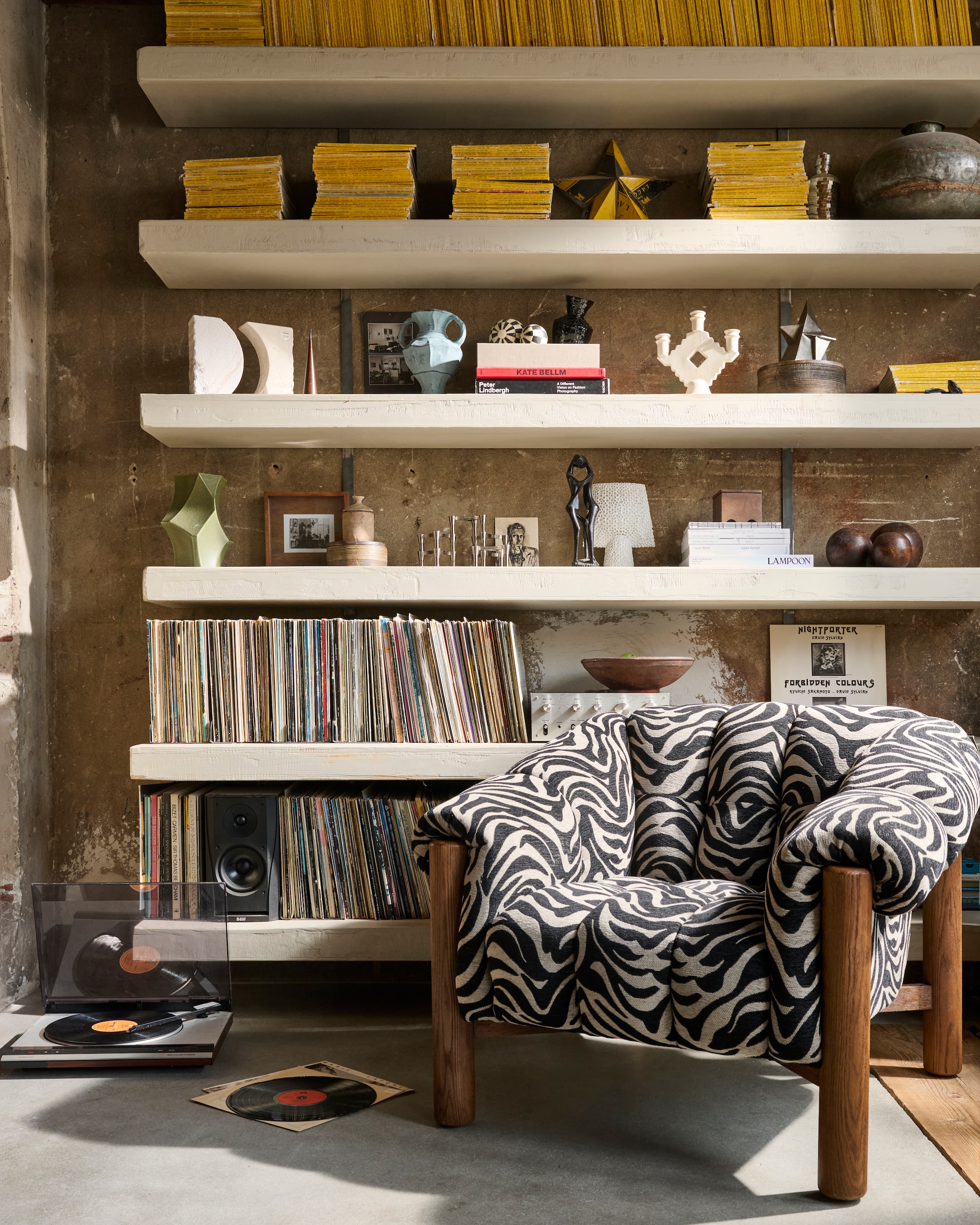 Loods 5 fauteuil James Zebra, stof en hout, 101x79x98 cm (bxdxh) € 995,- (loods5.nl). Urban Nature Culture fotolijst Caja, hout en glas, naturel € 31,99, decoratief object Runda Sand, marmerlook, zandkleur, 20,5x7,5x22 cm (bxdxh) € 99,- (shop.vtwonen.nl). Stoff Nagel kandelaars, chroom, per stuk € 45,- (bestwelhip.nl). HKliving vaas New Classics, blauw € 39,95, ornament Forge,metaal € 49,95, (hkliving.com).Ferm Living vaas geometrisch, keramiek, legergroen € 80,-, geurkaars met deksel, steen, crème € 35,- (fermliving.com). Zara Home grote ronde doos, hout, bruin € 39,99, rond houten kistje, bruin € 22,99, schuine vaas, aardewerk, zwart € 29,99 (zarahome.com). 101 Copenhagen vaas Sphere Square Shisen, wit € 79,- (101cph.com). Karwei kandelaar, beige € 17,99 (karwei.nl). Overig privébezit. vtwonen 04-2026 | styling sanne ketelaar | fotografie sjoerd eickmans