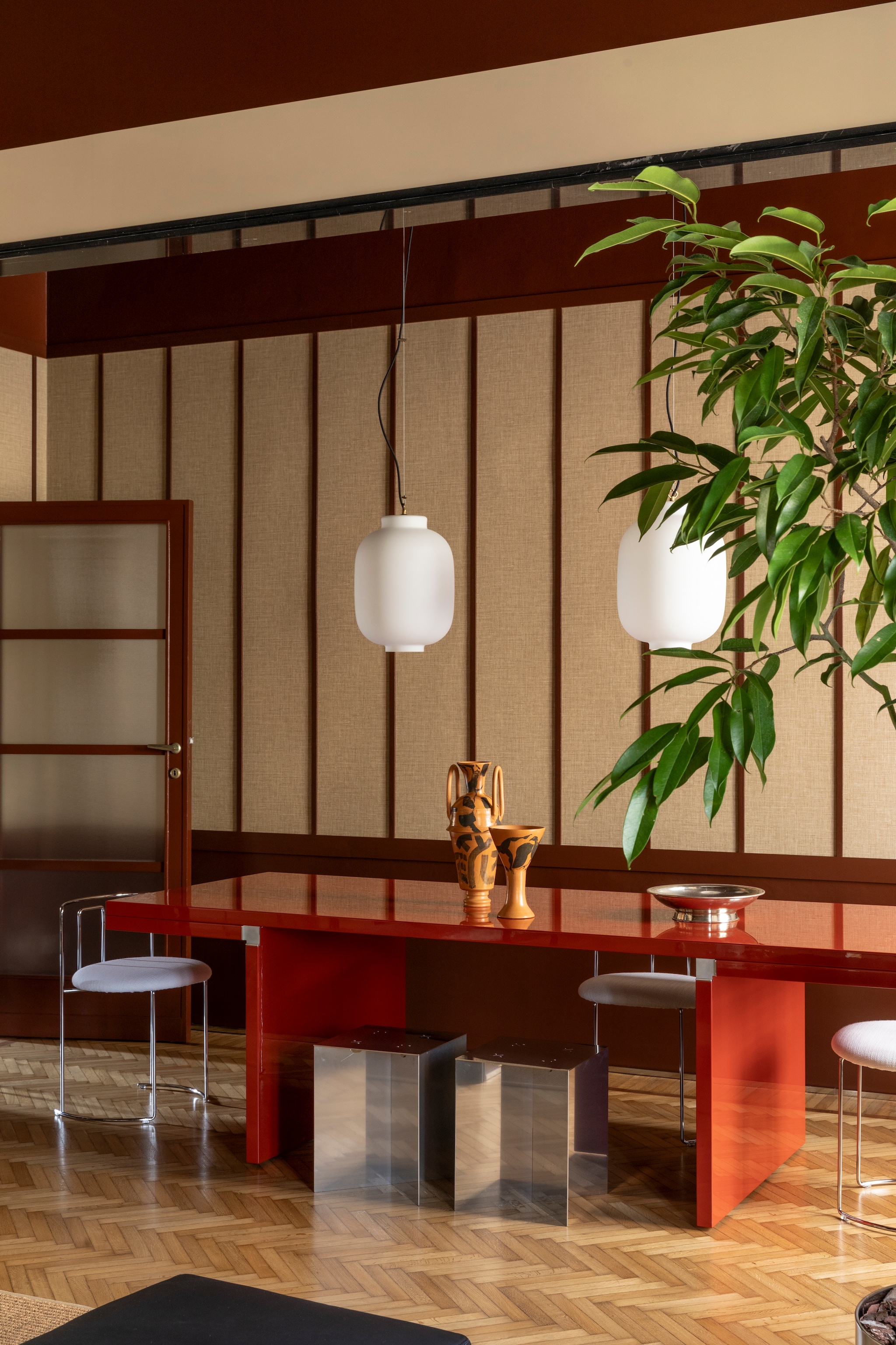 Eettafel Orseolo door Carlo Scarpa voor Cassina. Schaal Cnosso en vaas Ganimede van Damiano Groppi. Kunstwerk Geisha’s Painting van Paolo Gonzato via A Palazzo Gallery. Krukken Nm07 van Nm3. Stoelen Gaja van Kazuhide Takahama voor Cassina. Hanglampen Spazio Rt.