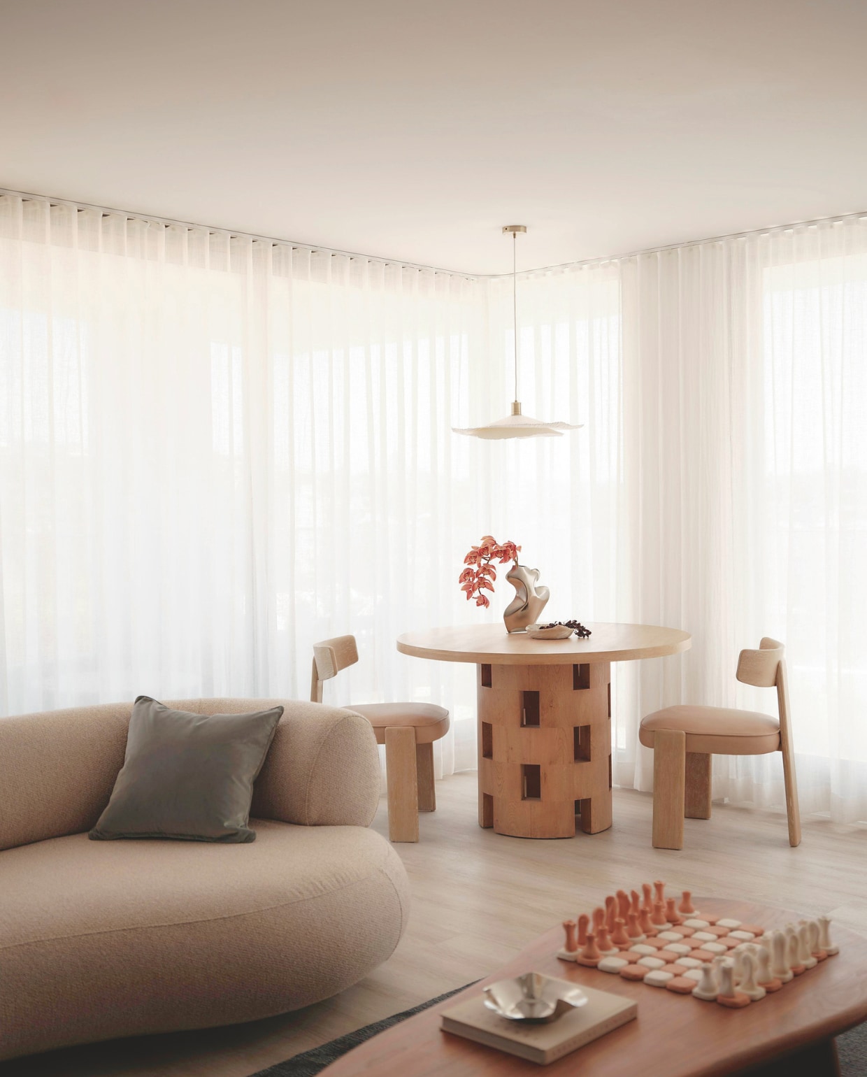 Bank maatwerk door E9 Design. Salontafel Fleur Studios. Eettafel Rachel Donath. Stoelen Casa Blanco. Vaas Duzi Objects. Papieren hanglamp Zara Home. vtwonen Design 01-2026 | fotografie Nic Gossage