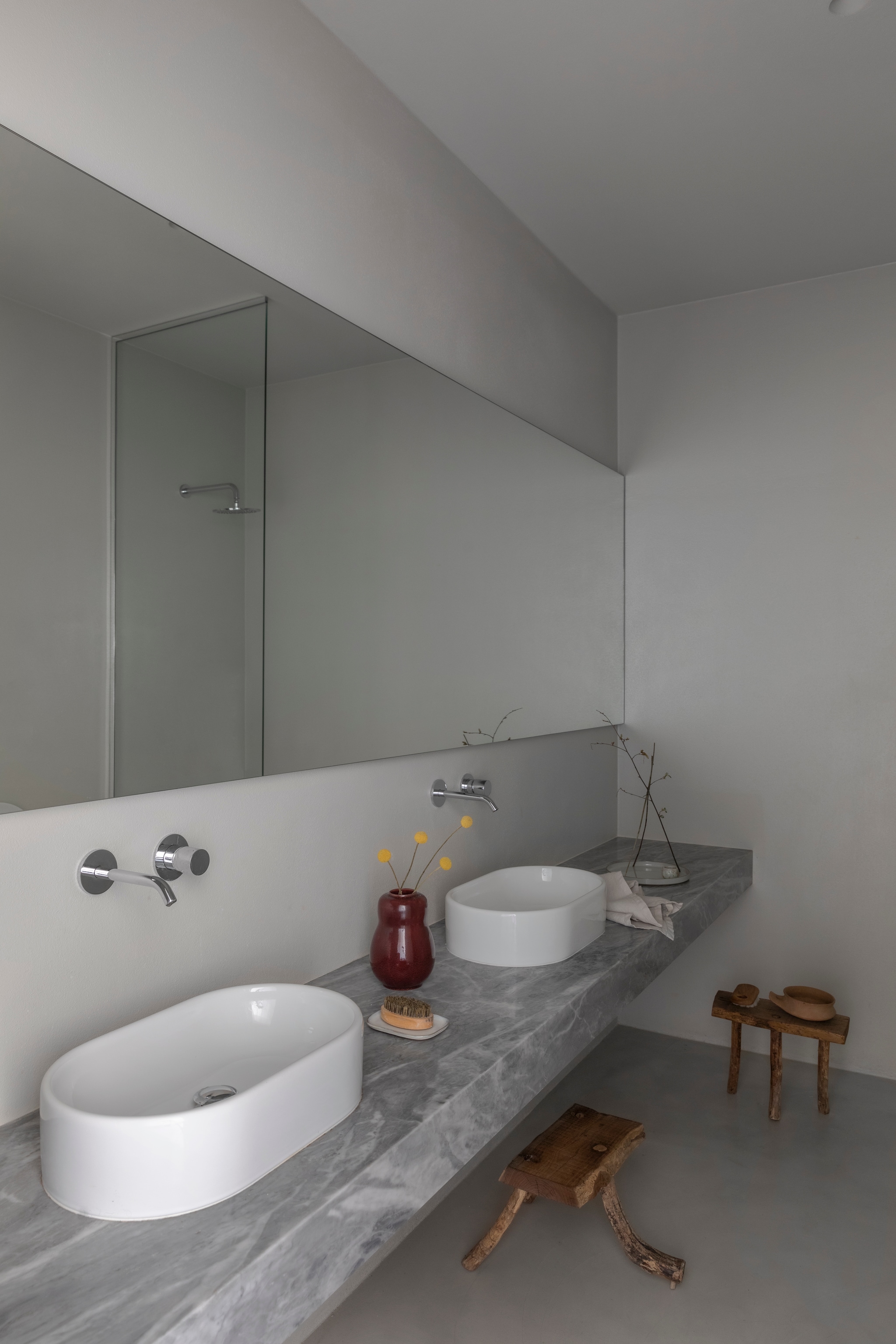Wastafel en kranen Azzurra Ceramica. Marmer Bardiglio van Marsotto. Jaren 40-vaas van Carl Halier voor Royal Copenhagen. Krukken van oud hout gemaakt door Moreno’s vader. vtwonen Design 04-2026 | styling Chiara Dal Canto | fotografie Helenio Barbetta | productie Living Inside