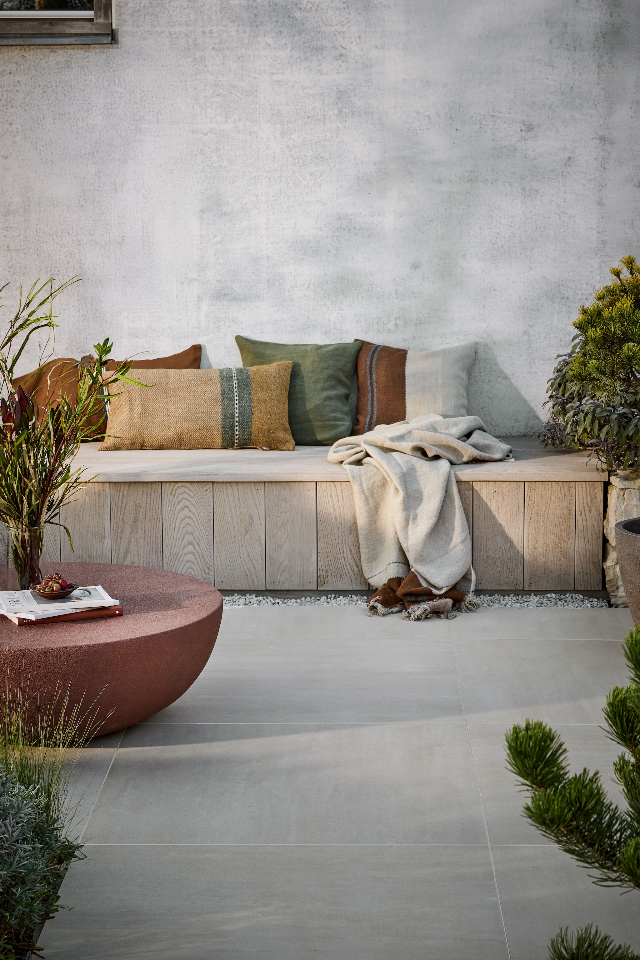 vtwonen tuintegel Form, keramiek, beige, 45x90 cm (lxb) en 90x90 cm (lxb), per m² € 84,50.M.m.v. libecohomestores.eu (kussens en plaid). Overig privébezit. vtwonen 04-2026 | styling Kim van Rossenberg | fotografie Peggy Janssen