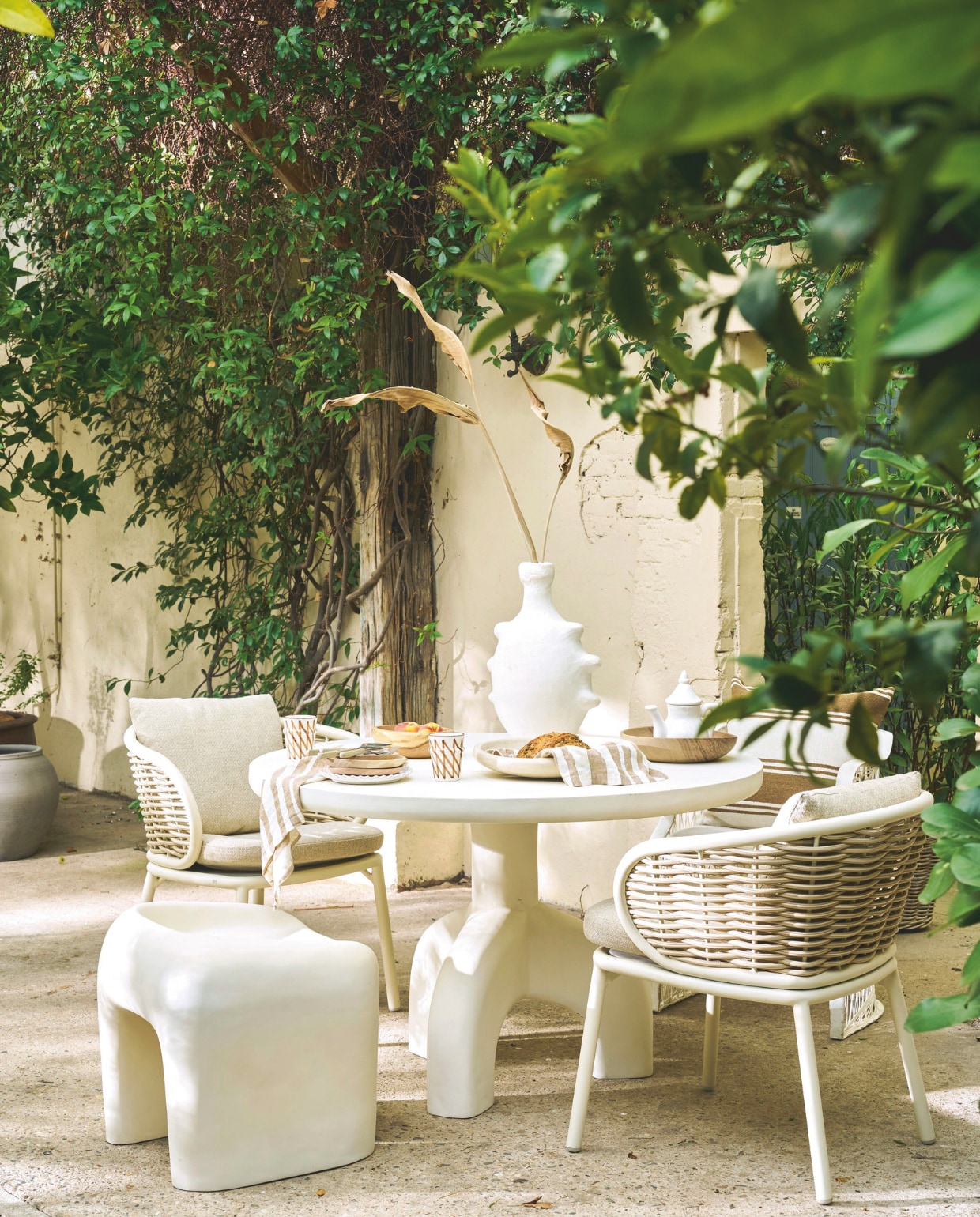 Woood tuintafel Luno, vezelversterkt polymeer, 120x76 cm (Øxh) € 1099,-, kruk Nivo, vezelversterkt polymeer, 52x50x51 (bxdxh) € 329,-, HKliving bestek 70’s, roestvrij staal, 16-delig € 129,- (shop.vtwonen.nl). Household Hardware schaal, hout € 49,-, bekers Fez, keramiek € 14,95, fruitschaal, tadelakt € 69,-, vaas Yassin, mix van cement en marmerpoeder, wit € 115,-, borden, walnoot € 21,-,stoel Vanessa, polyester, 57x57x55cm (bxdxh) € 429,-, theepot, keramiek€ 49,-(householdhardware.com). Omar buitenkussen Olga, breed gestreept, crème-bruin, inclusief vulling € 125,- (omar-antwerp.be). Apple Bee tuinstoelen Pine Key, aluminium frame en weerbestendige kussens, oyster € 369,- (applebee.nl). Overig privébezit. vtwonen 03-2026 | styling Cleo Scheulderman | fotografie Jeroen van der Spek