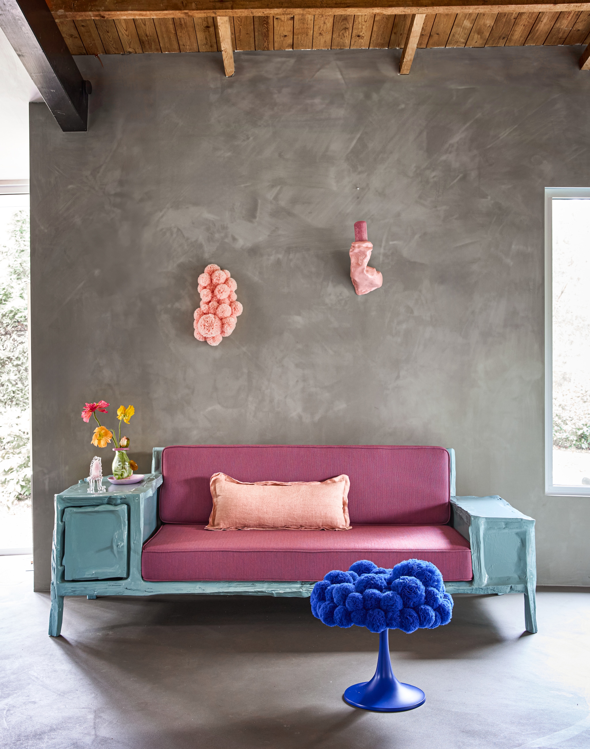 Teun Zwets bank Splitted Seater, douglashout, blauw en roze, 255x90x70 cm (lxbxh) € 16.500,- (frozenfountain.com). Sofie Aaldering kruk Tulip, tule, blauw, 50x50 cm (Øxh) € 4500,-, wandobject Spring Flower, organza en schuim, roze, 30x15x50 cm (bxdxh) € 1800,- (rademakersgallery.com). Junoon by Janice Jill wandkandelaar Retkakeeda, keramiek, pink, 30x17x24 cm (bxdxh) € 425,- (instagram.com/junoonbyjanicejill). Sandra Keja Planken vaas, glas, groen en roze, prijs op aanvraag (sandrakejaplanken-noun.com). Meester in bloemen bloemen, prijs op aanvraag (meesterinbloemen.nl). Debby Eerens miniatuurstoel, glas, roze en wit € 75,- (deoudehorn.com). Hkliving kussen Magnolia, linnen, peach € 59,95 (hkliving.com). Overig privébezit. vtwonen 06-2026 | styling Kelly van Gendt | fotografie Peggy Janssen