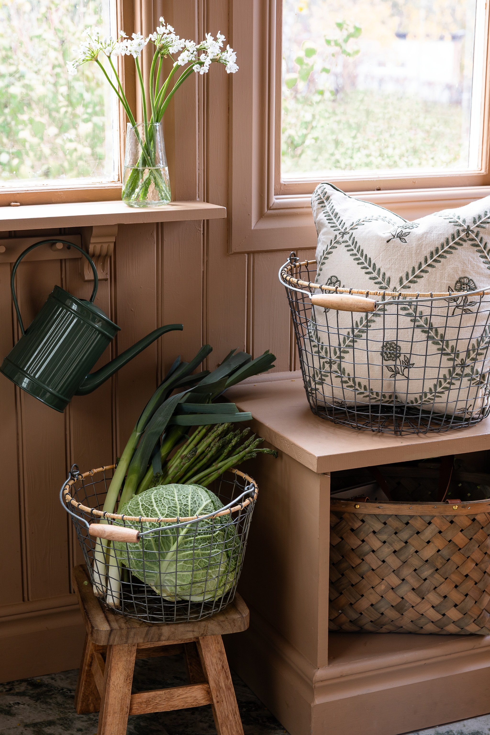 Strömshaga mand Wire, ijzerdraad met houten handvat, grijs € 48,80, mand Monica, hout, grijs, set van 3 € 43,26, vaas Sara, glas, 8x14 cm (Øxh) € 15,11, gieter Hugo, ijzer, donkergroen € 48,80 (stromshaga.se). vtwonen Landelijk 06-2026 | Stromshaga