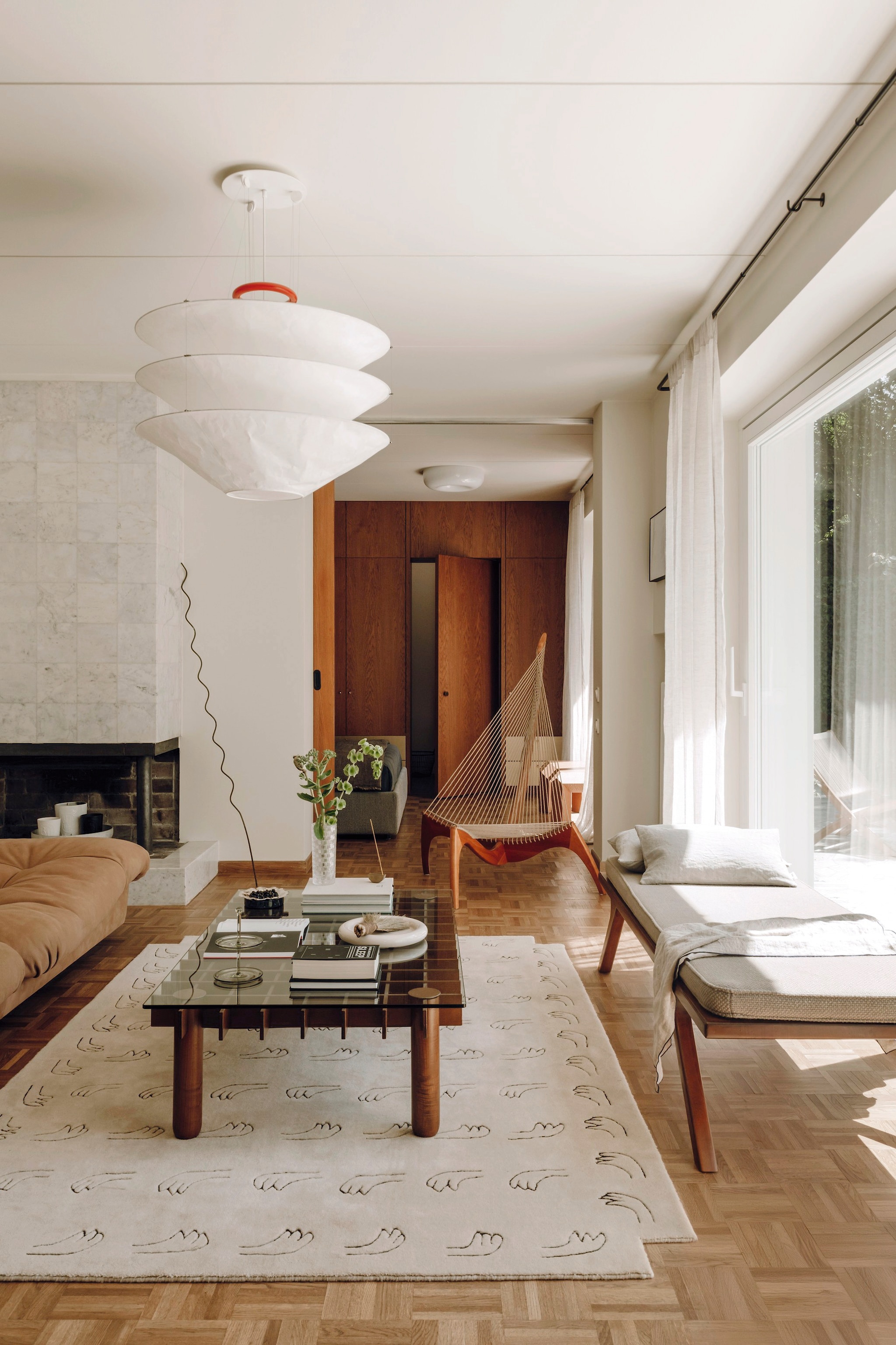 Lamp Floatation van Ingo Maurer. Bank Milano van Baxter. Vintage salontafel Kyoto van Poltrona Frau. Daybed maatwerk uit Polen. Stoel Harp van Jørgen Høvelskov.