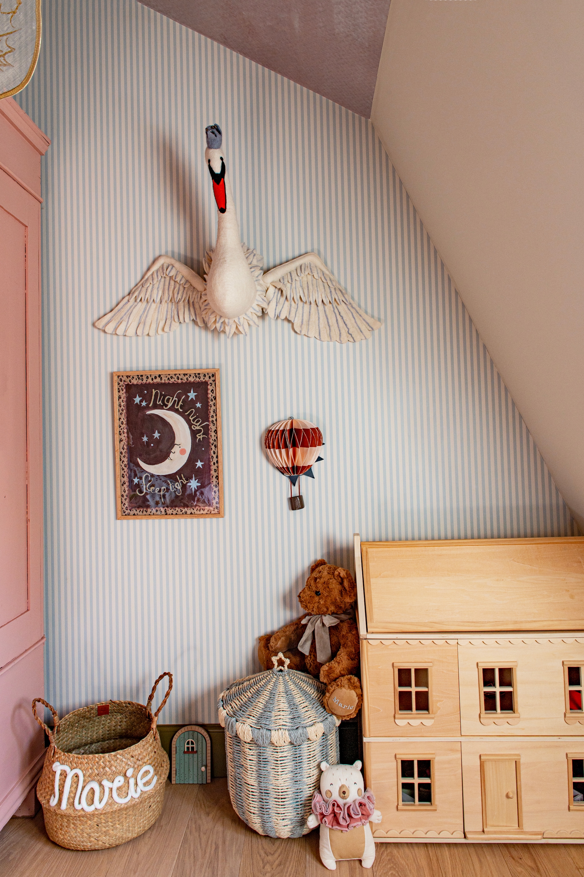 Behang Farrow & Ball. Oude kast uit Robs ouderlijk huis, roze geverfd. Zwaan Lidor. Luchtballon, kabouterdeur en mand Zara Home. Poppenhuis Petite Amélie. Knuffel Birth Bear. Eiken plankenvloer Bart Beugt. vtwonen Special 03-2026 | fotografie Caroline Coehorst | productie De Binnenkijkers by Caroline