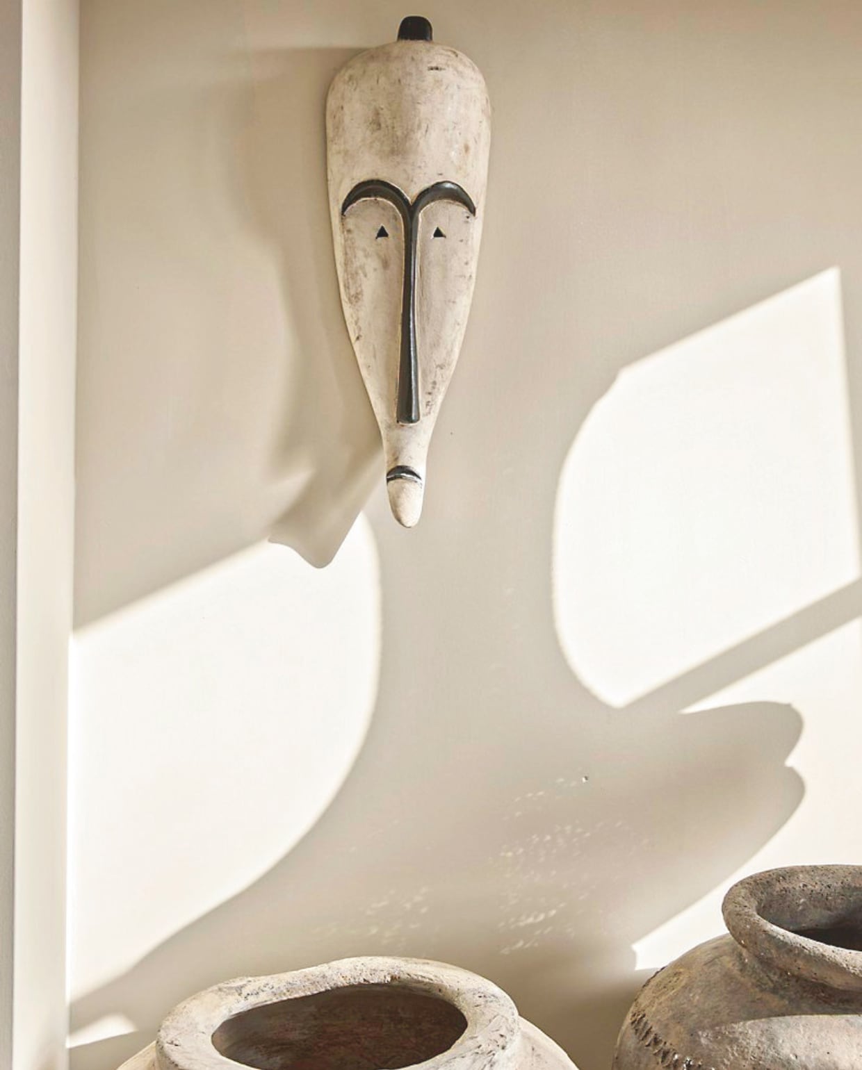Muurkleur French Linen van Painting the Past. Masker uit Afrika. Kruiken ’t Potterieke. vtwonen Landelijk 05-2026 | styling Kristel van Leeuwen | fotografie Peggy Janssen