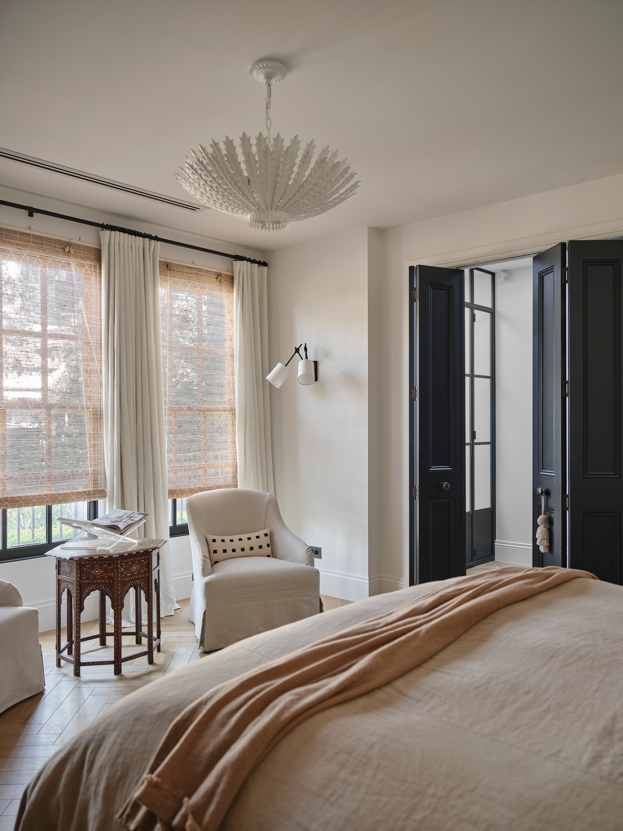 Fauteuil Dresden van Coco Republic. Antieke bijzettafel uit Hoshiarpur. Kroonluchter Hampton van Aerin. Beddengoed Cultiver. Stoelkussen Dekowe. Bamboe jaloezieën Namay Samay. Visgraatvloer eiken. vtwonen Landelijk 9-2026 | fotografie Lisa Cohen