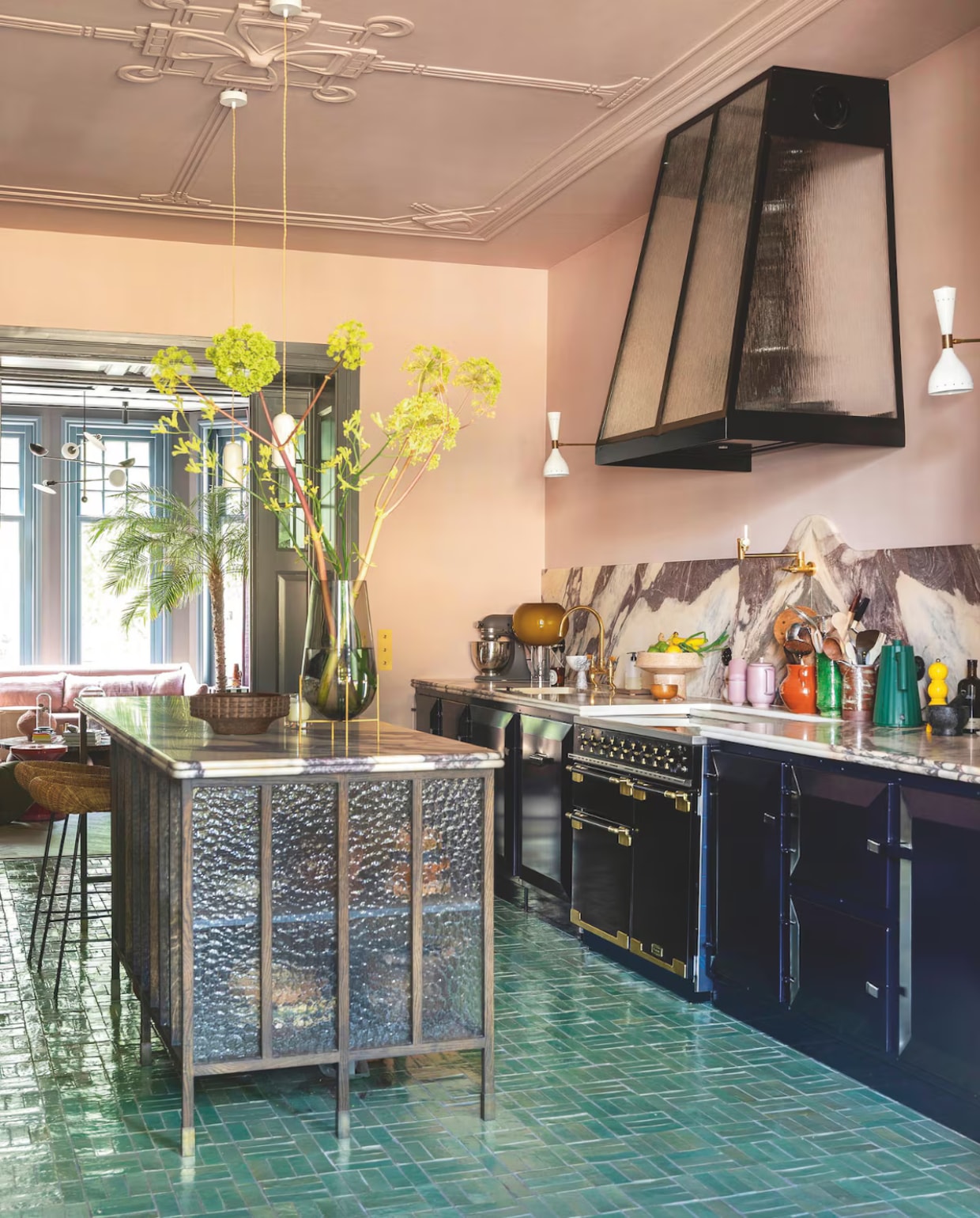 Kleur plafond en muren Fine Plum van Flexa Pure, vloer Designtegels, keuken en afzuigkap Martens & Dochters, fornuis Falcon, marmer Jan Reek natuursteen. Wandlampen Etsy, tafellamp met gele kap Foscarini. Keukeneiland ontworpen door Form Makers, uitgevoerd door 180 Graden Zuid, barkrukken HKliving, schaal Zara Home, vaas Audo. vtwonen 09-2025 | styling & fotografie Theo Bert-Pot, Jelle van de Schoor
